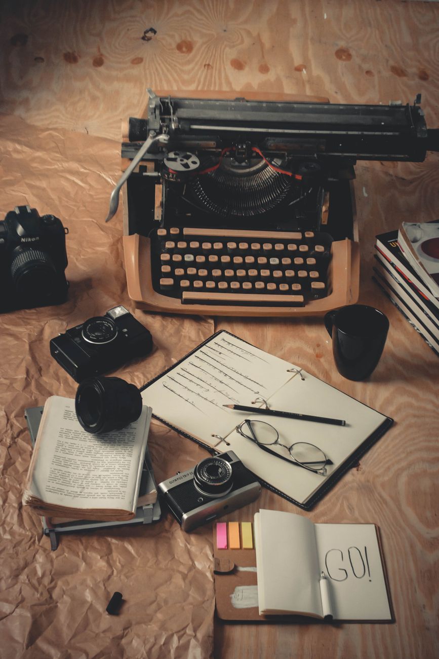 Quiet studio work table with photography gear and journals
